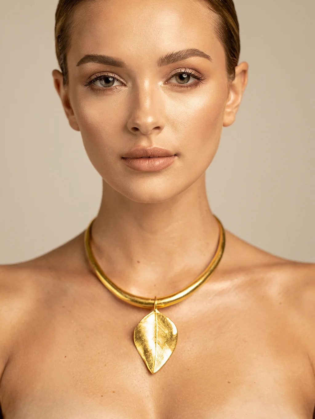 Close-up of elegant jewelry worn against minimal styling, jewelry as dominant visual.